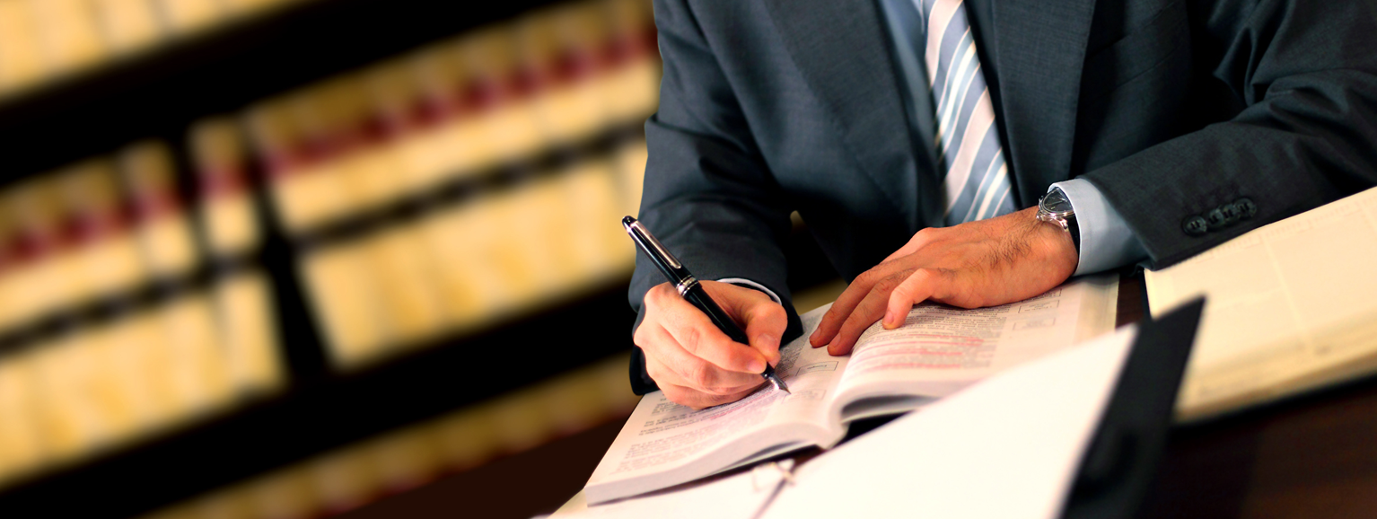 Law library with lawyer reviewing law books